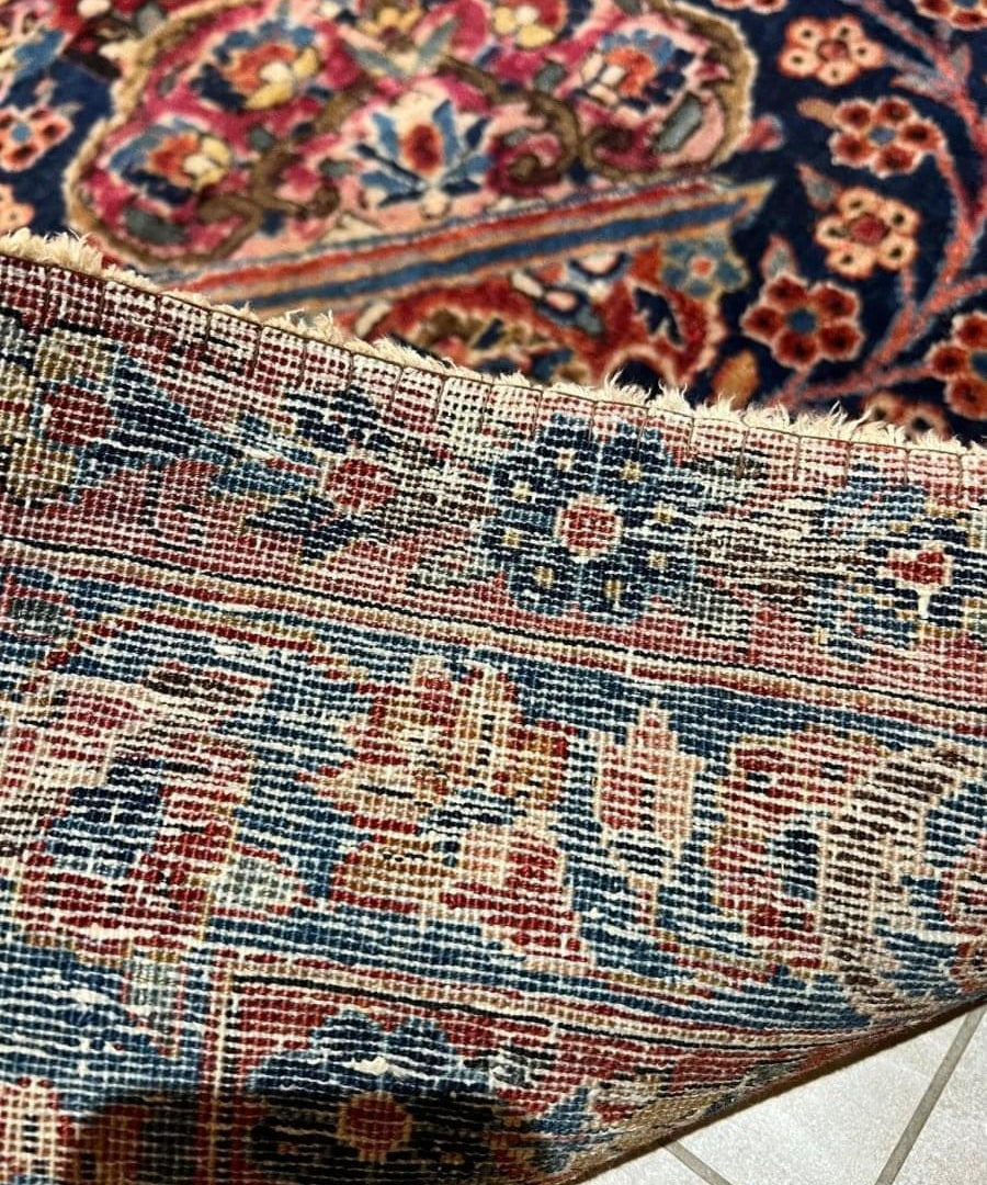 Persian Sarouk rug border detail with woven fringe edge and multicolor patterning