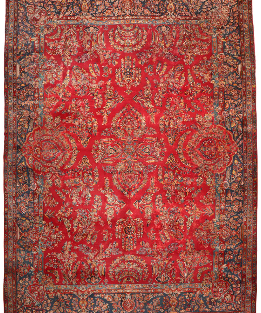 Antique Persian-style Sarouk rug, red field with navy border and detailed medallions