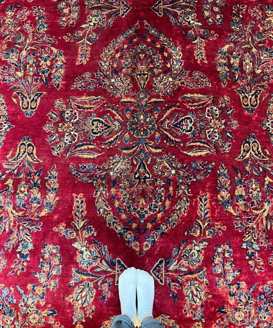 Red Persian-style Sarouk rug close-up with central medallion and ornate floral motifs