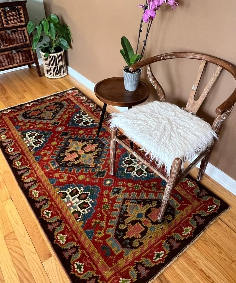 Eastern European rug 6'6" x 3'3", dark red with multicolor geometric medallions