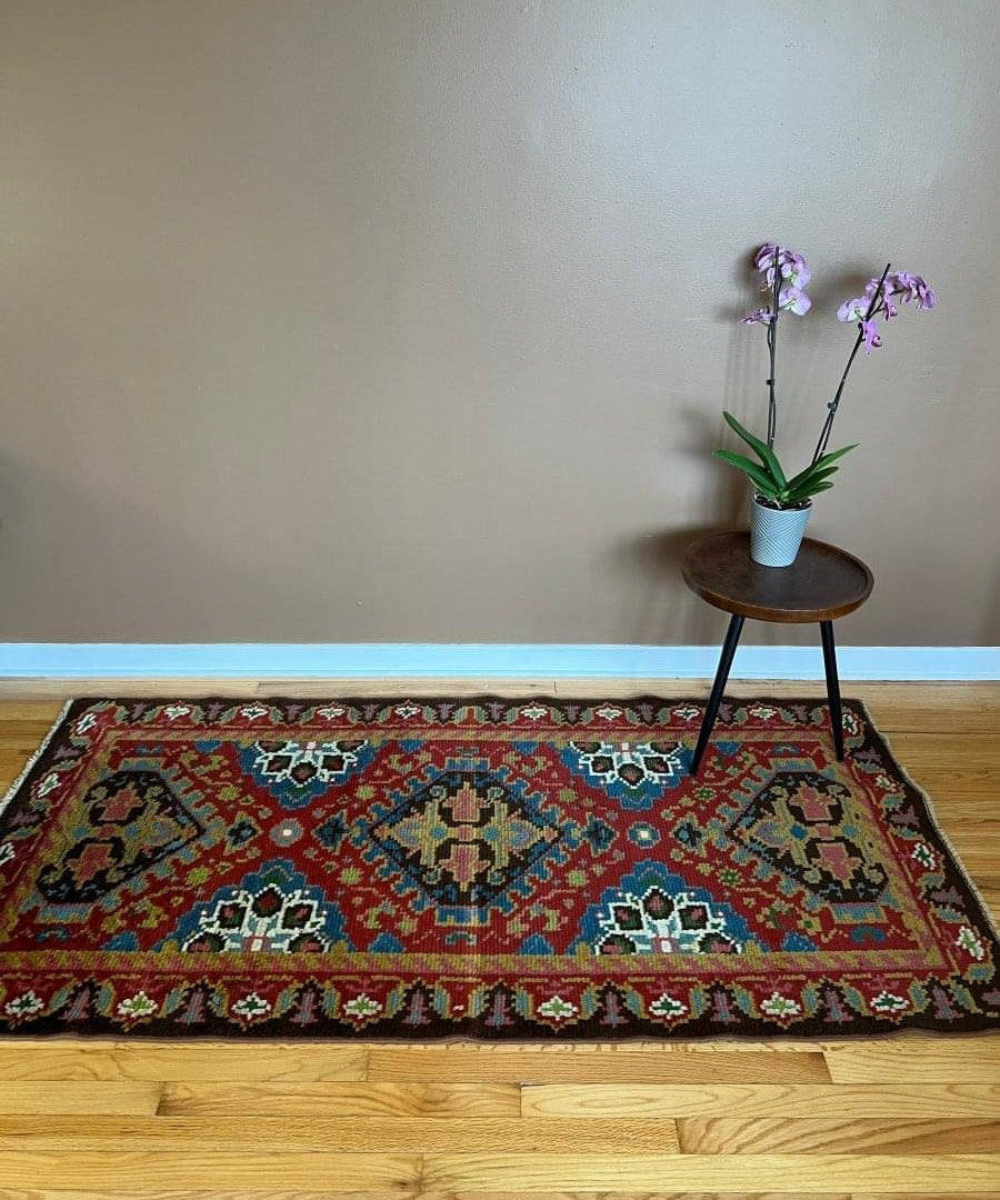 Eastern European rug 6'6" x 3'3", red ground with blue central medallion and border