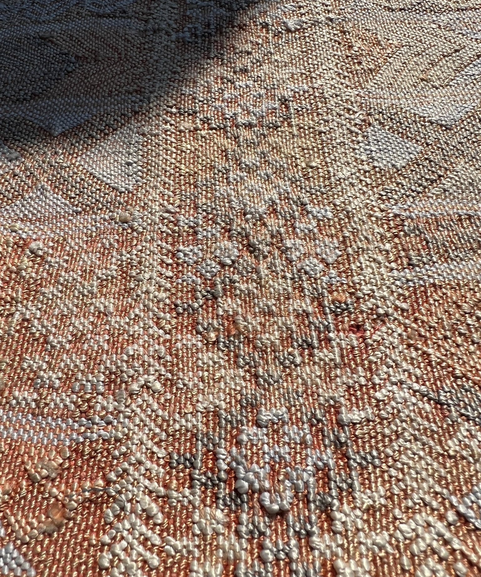 Moroccan woven rug close-up, speckled tan and beige thread with diamond patterns