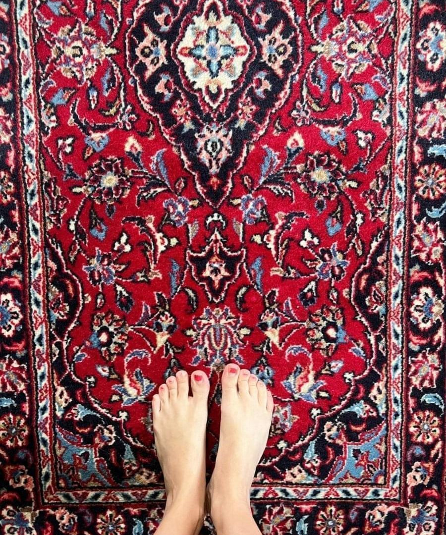 Persian Kashan runner rug, dark red field with navy floral motifs and blue medallion.
