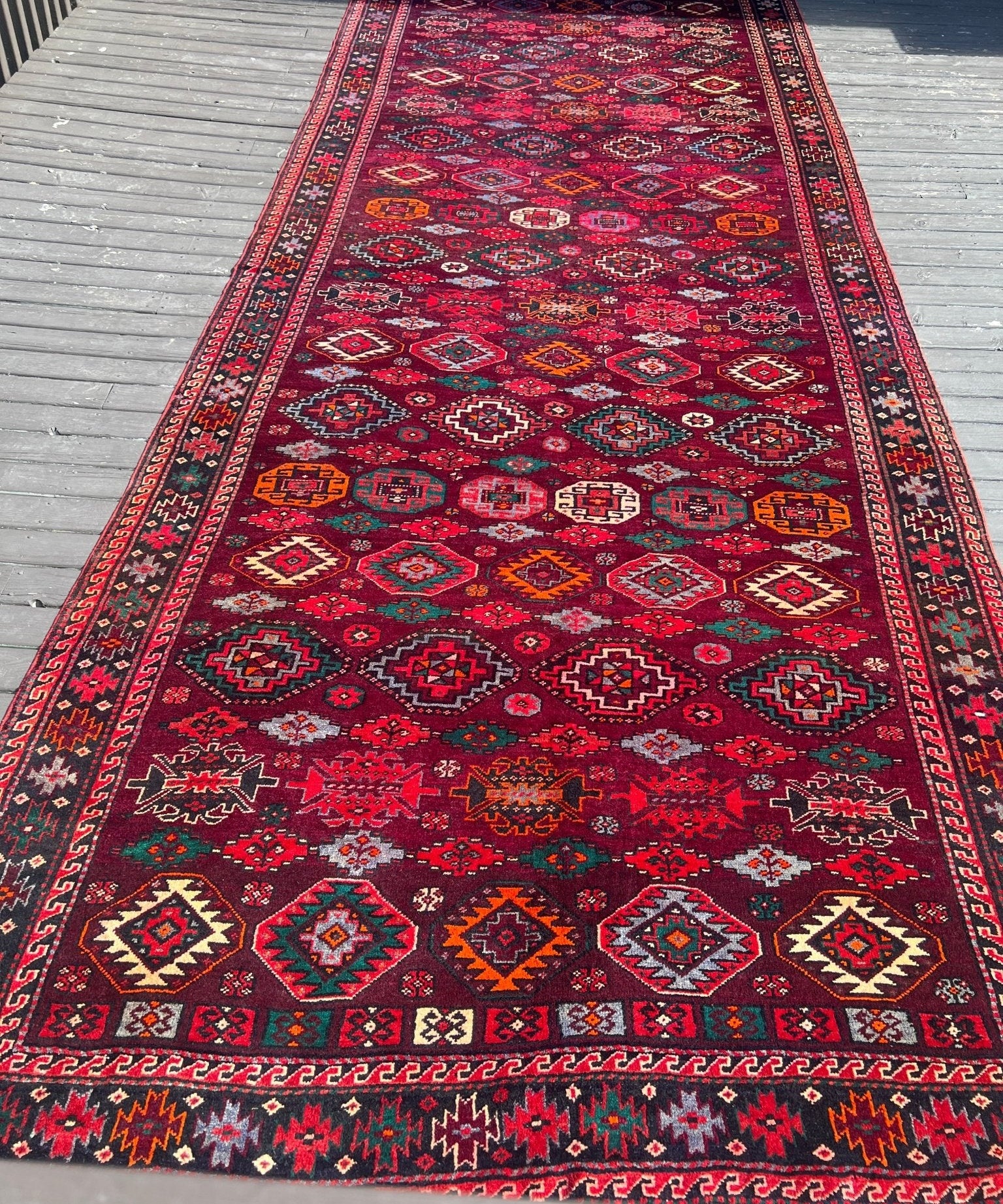 Persian Quchan rug runner with dark red center medallions and multicolor diamond patterns