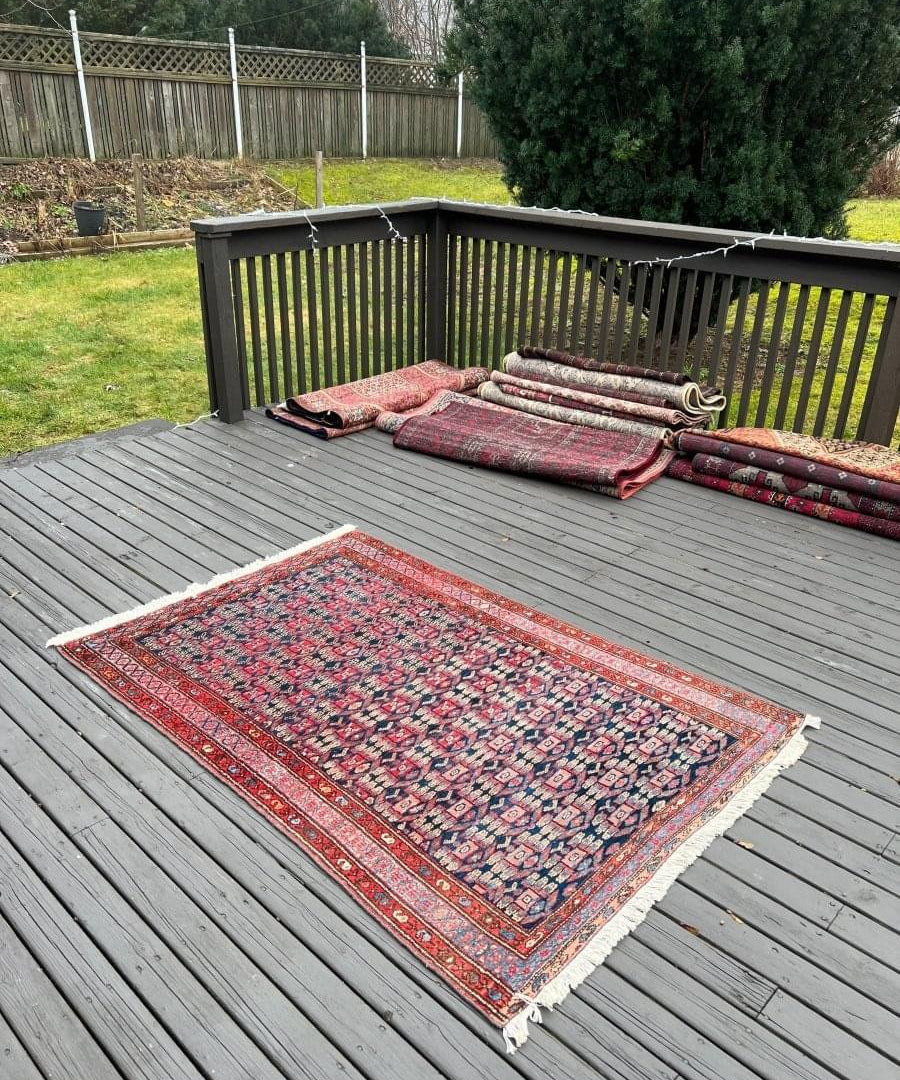 Persian Hamadan rug with red border and blue geometric pattern, fringed edges