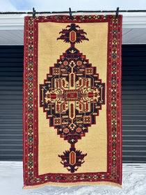 Persian Heriz soumak rug, cream field with navy and burgundy geometric medallion