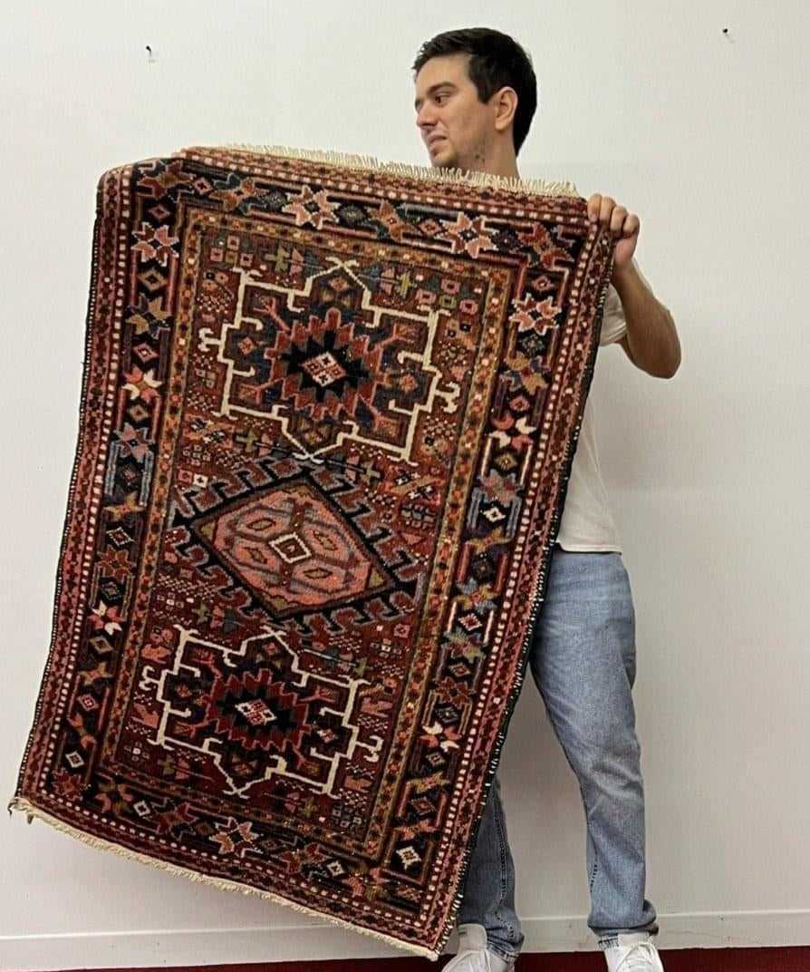 Persian Karaja rug with maroon geometric medallion and navy accents.