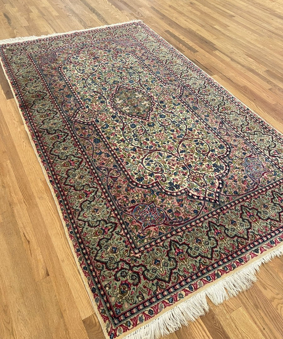 Persian rug corner view with fringe, central medallion, and red navy border