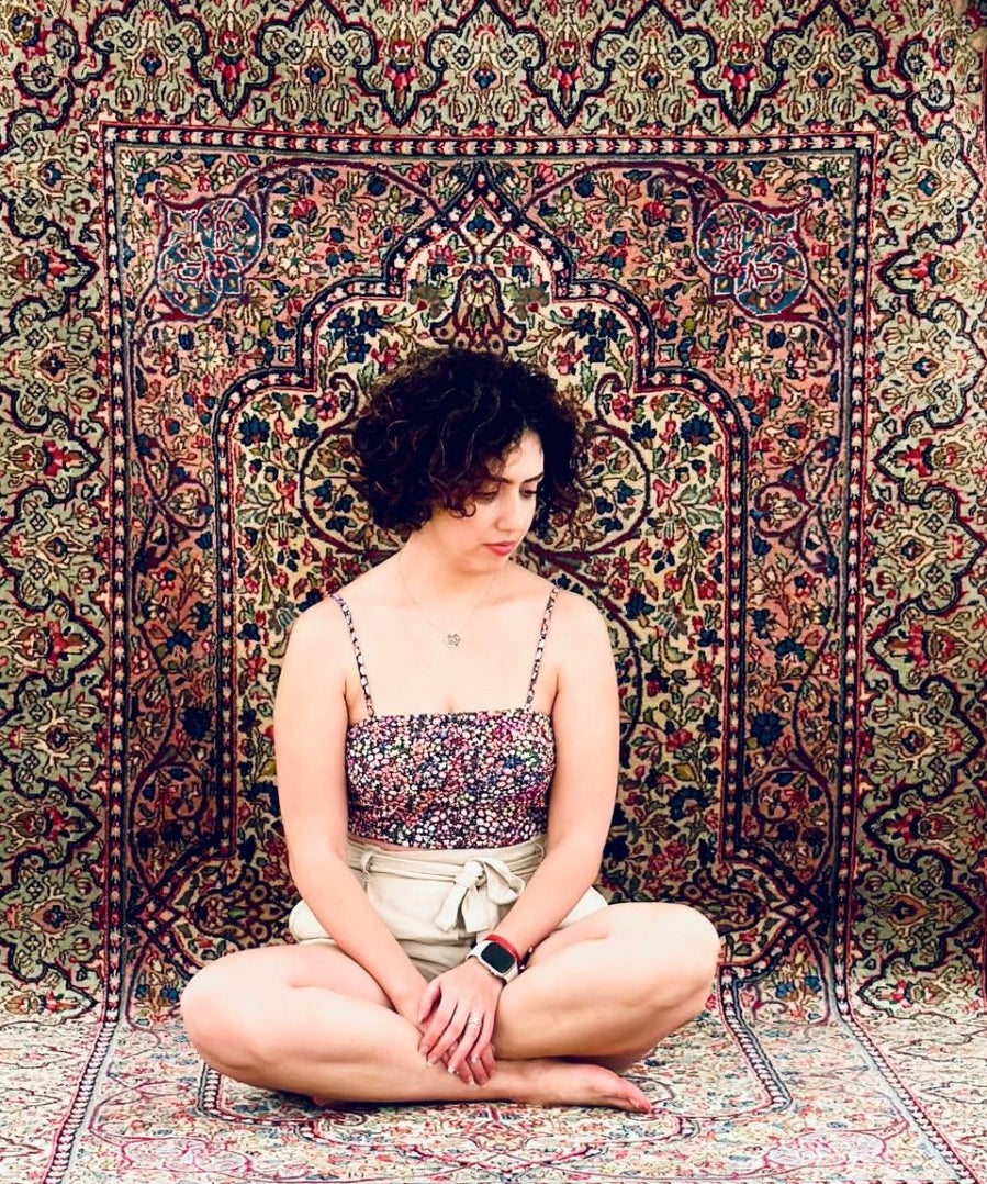 Persian rug with dark navy border and multicolor floral central medallion