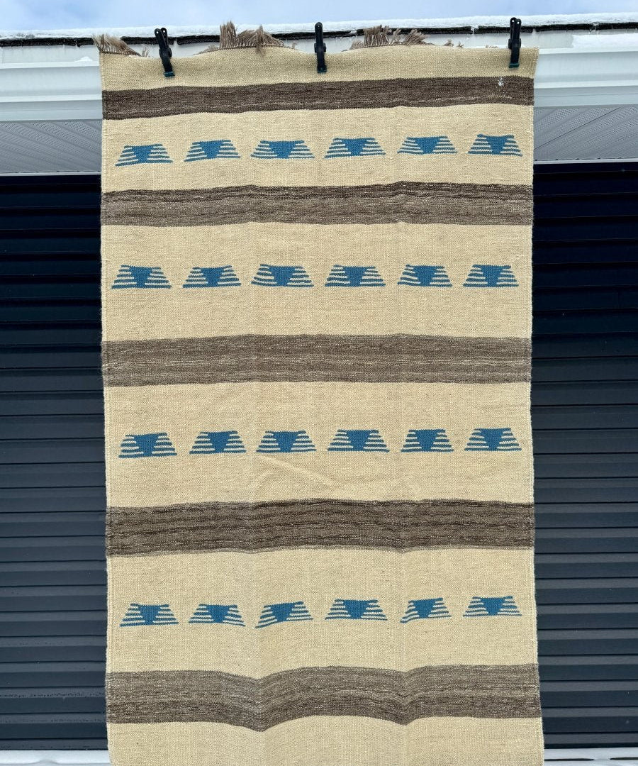 Persian kilim rug with beige ground, blue geometric bands, dark stripes, fringe edges