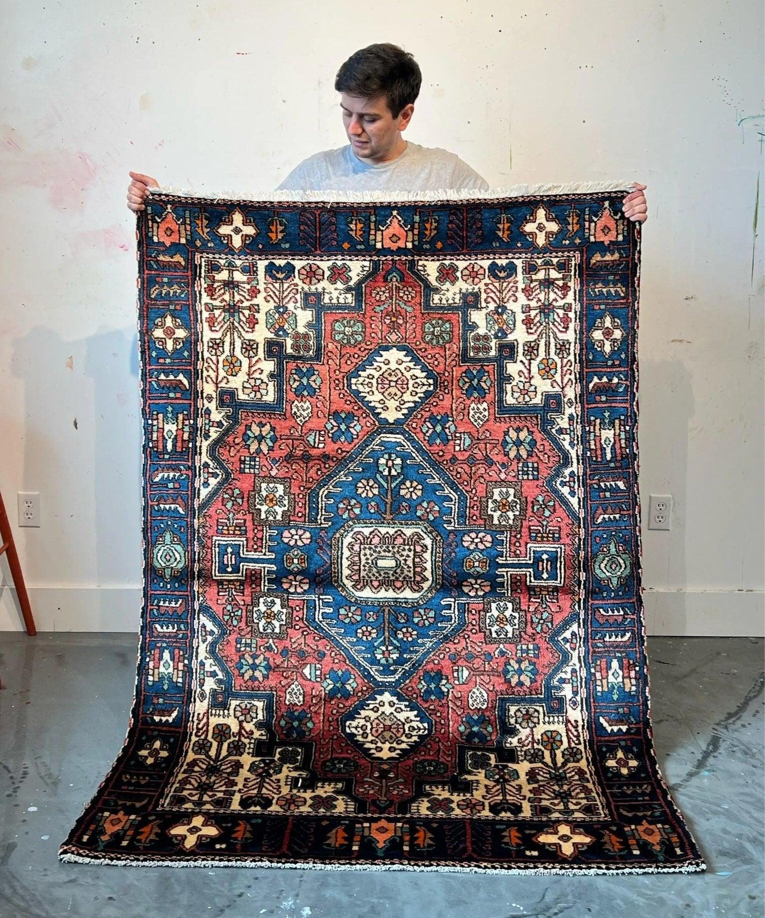 Persian Nahavand rug with red, blue and cream medallion, decorative border and corner details