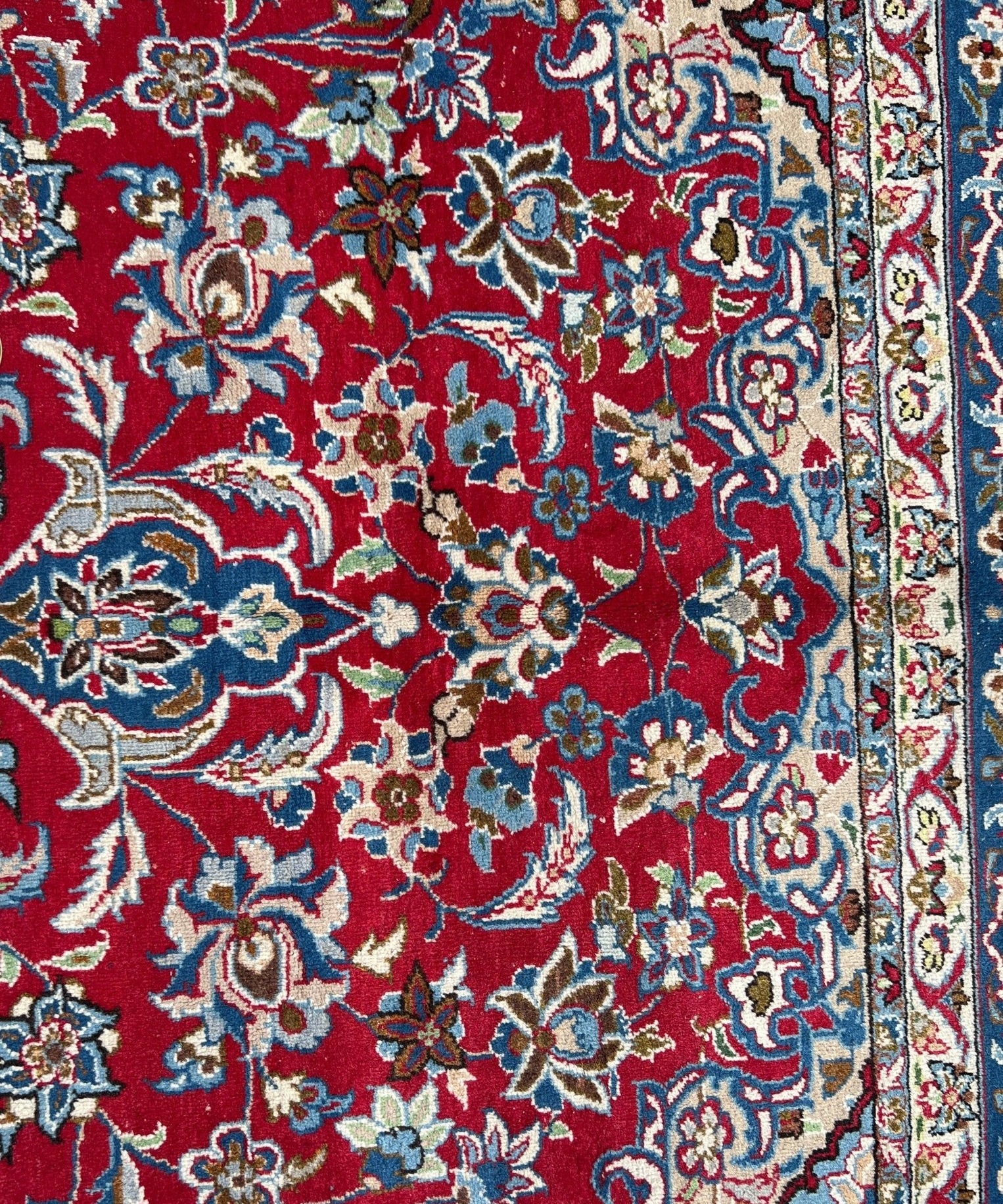 Close-up of red and blue Persian-style rug pattern with detailed floral medallions