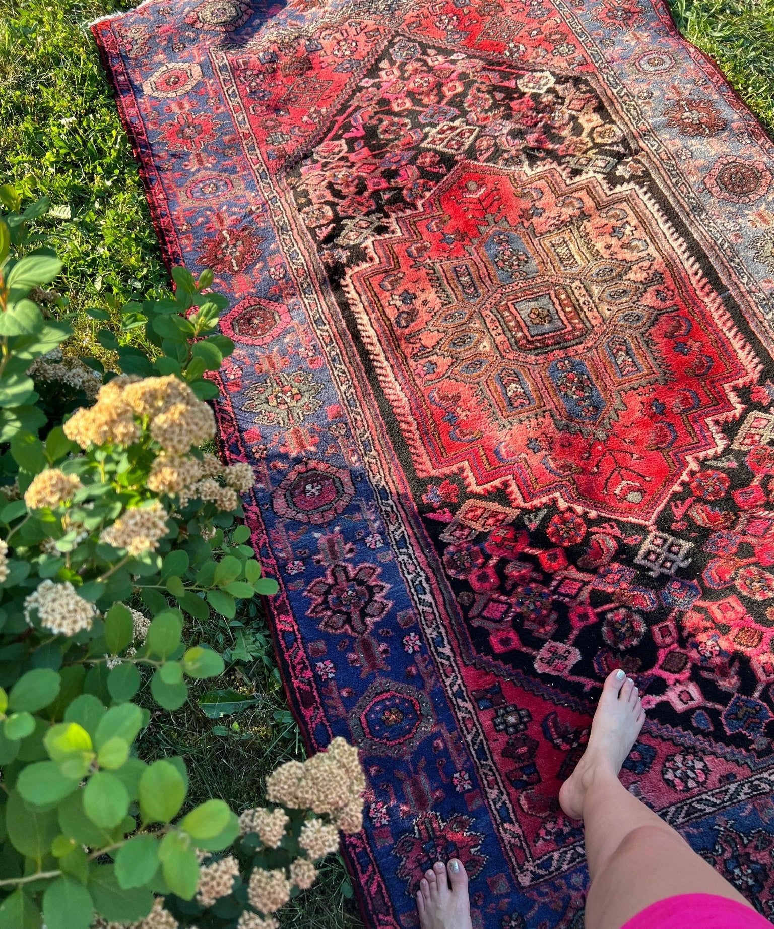 Maroon and navy Persian rug with geometric motifs and central medallion