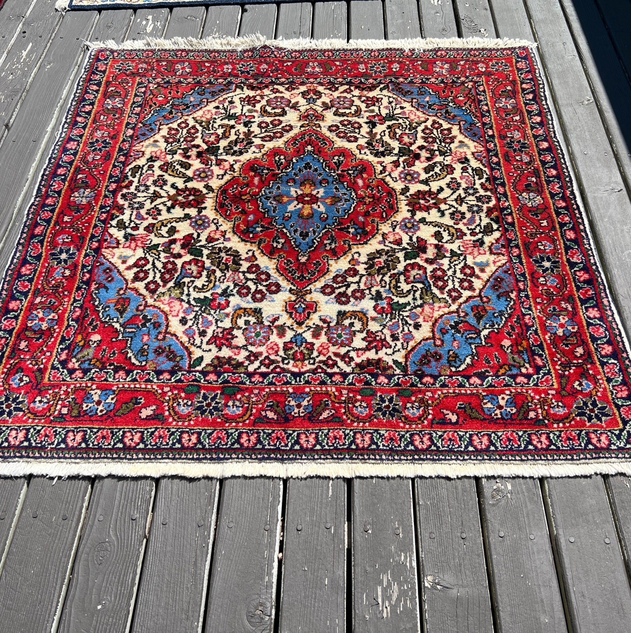 Persian rug square with central medallion, red frame and multicolor pattern