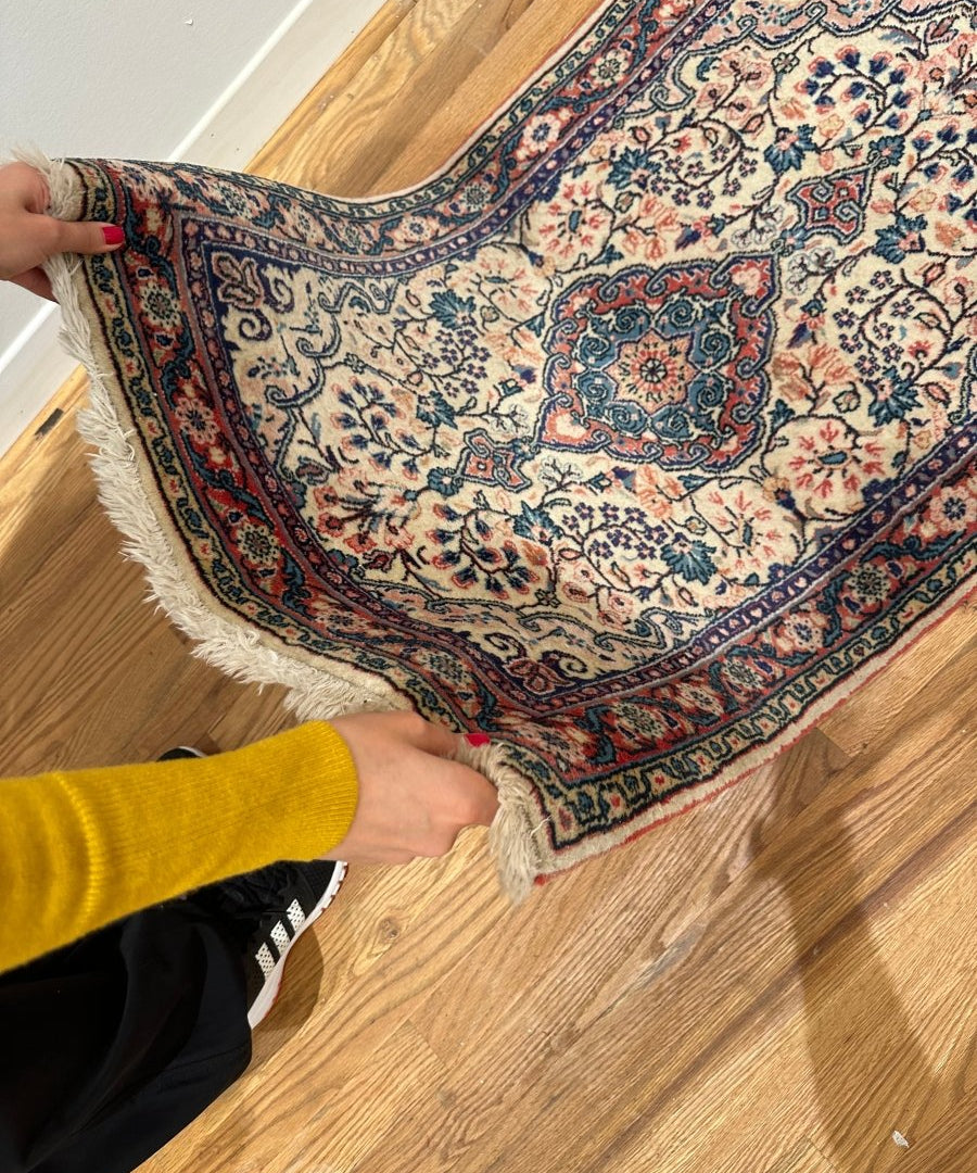 Persian Sarouk rug with cream floral medallion, blue and red border, fringed ends