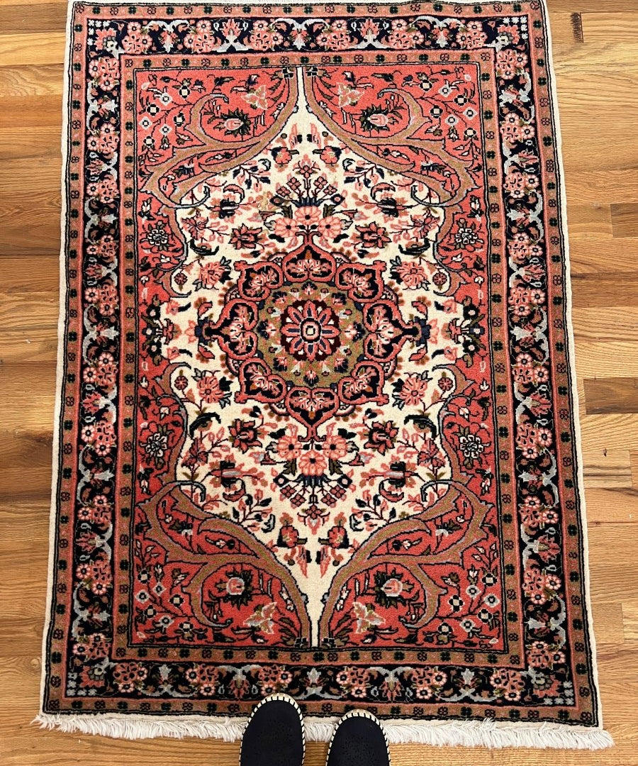 Persian Sarouk rug, square layout with red and cream ornate center medallion, fringe edges