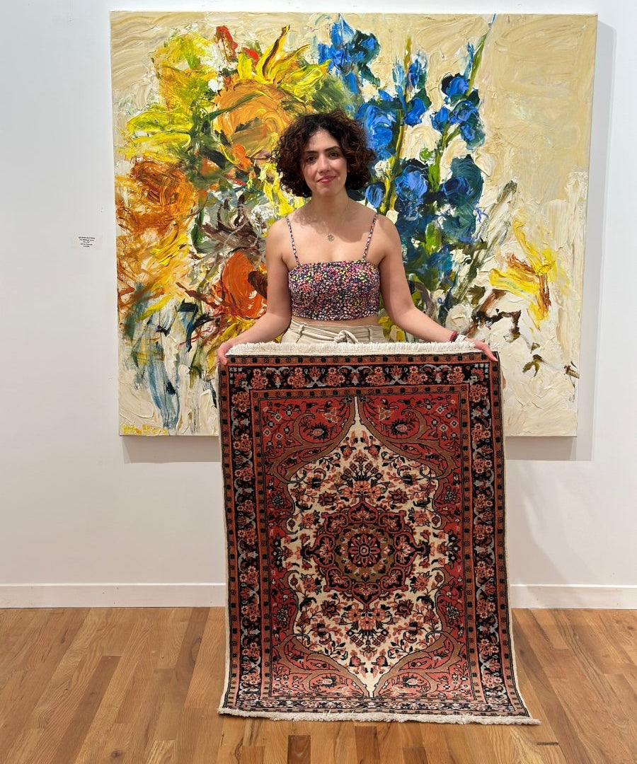 Persian Sarouk rug with red, cream, and dark floral medallion pattern, short fringe
