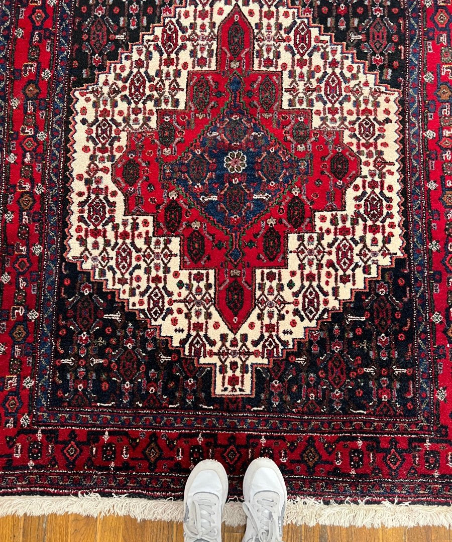 Persian Senneh rug with red medallion, cream lattice, navy background