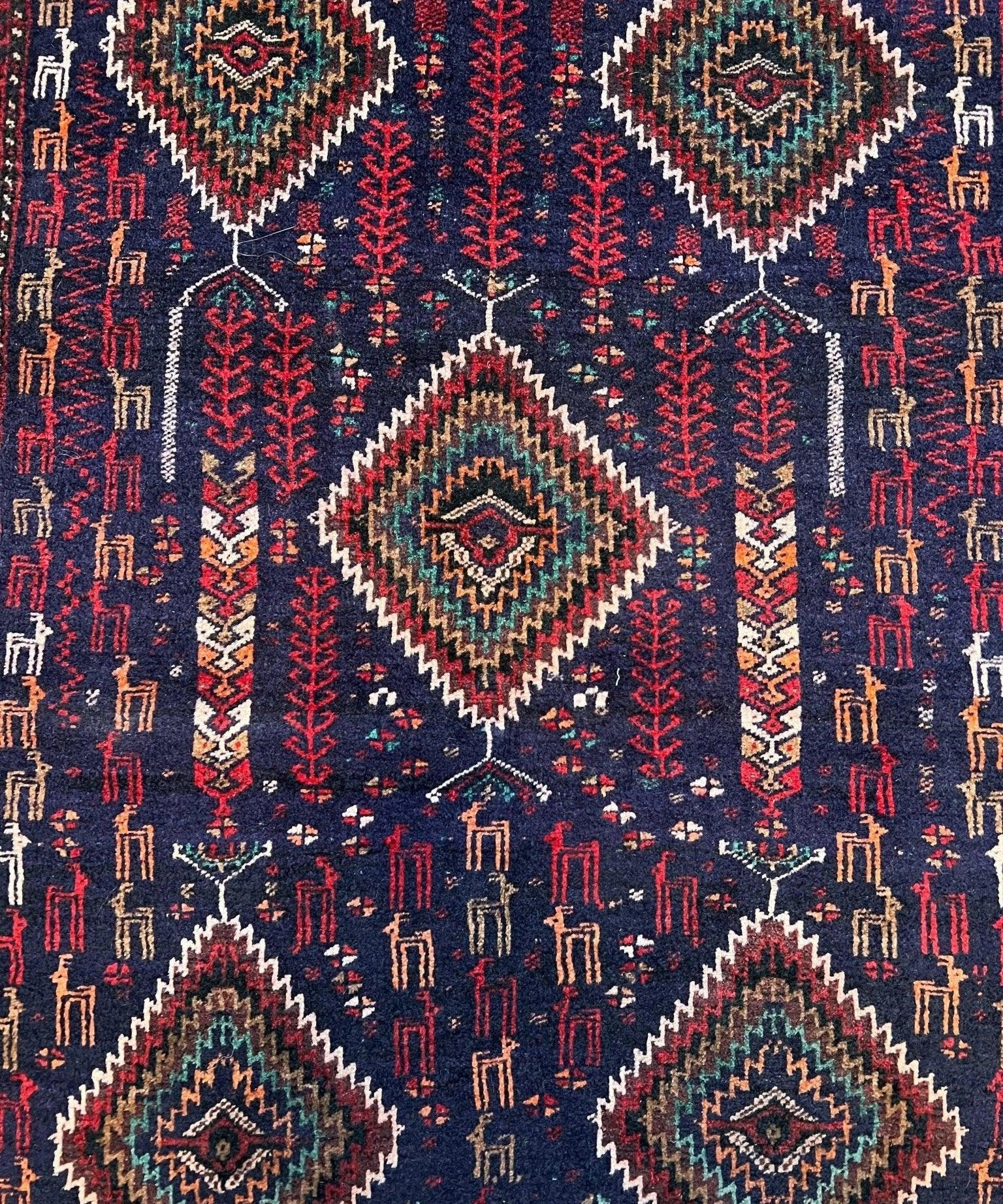 Handwoven rug, navy with red accents and multiple diamond motifs