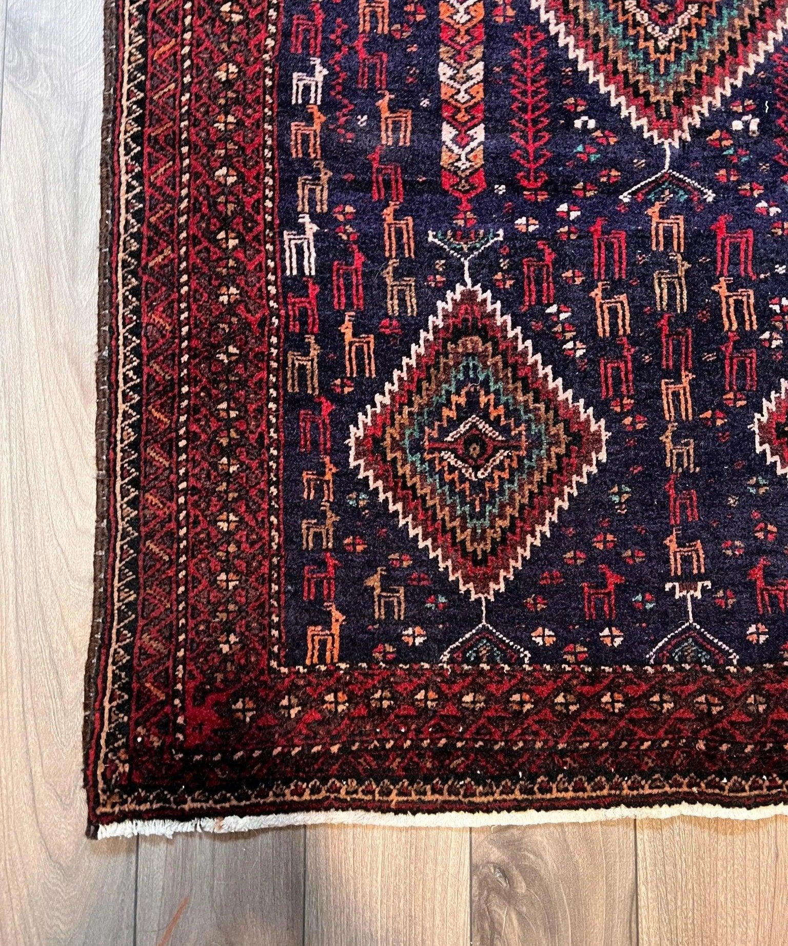 Persian Zabol rug with navy field, red border, diamond medallions
