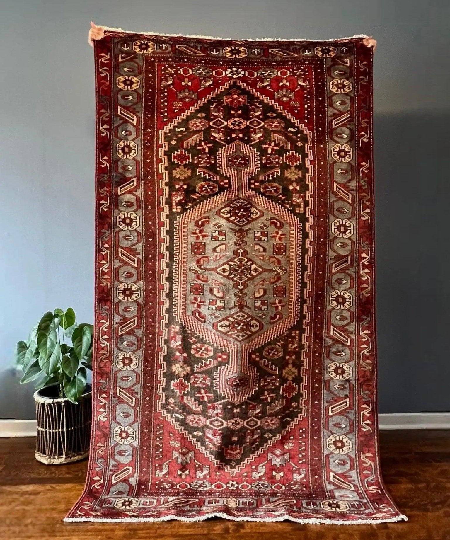 Persian Zanjan rug with red field, cream medallion, geometric border, 7x4 ft