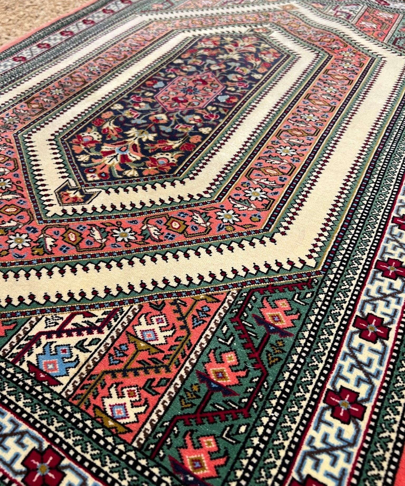 Multicolor Persian-style rug with red center medallion and floral border detail