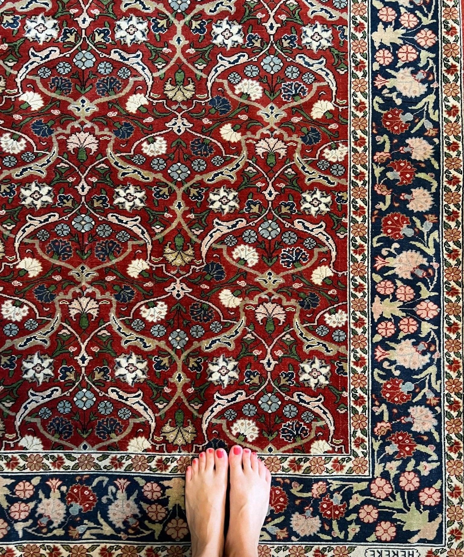Red and navy Persian-style rug with floral medallion pattern and border, 7’1"x4’8"