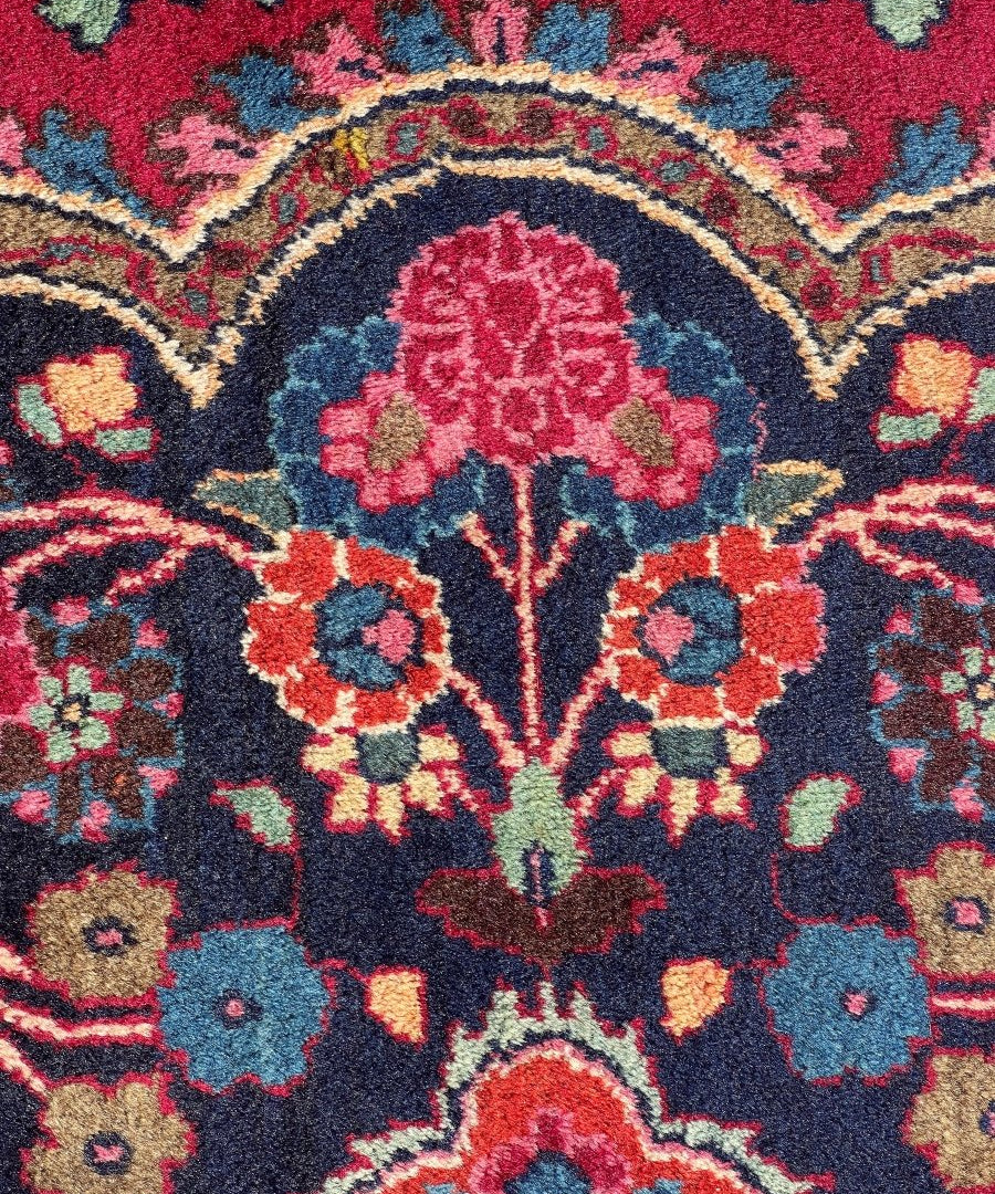 Persian Mashad rug floral medallion detail in red, blue, and cream