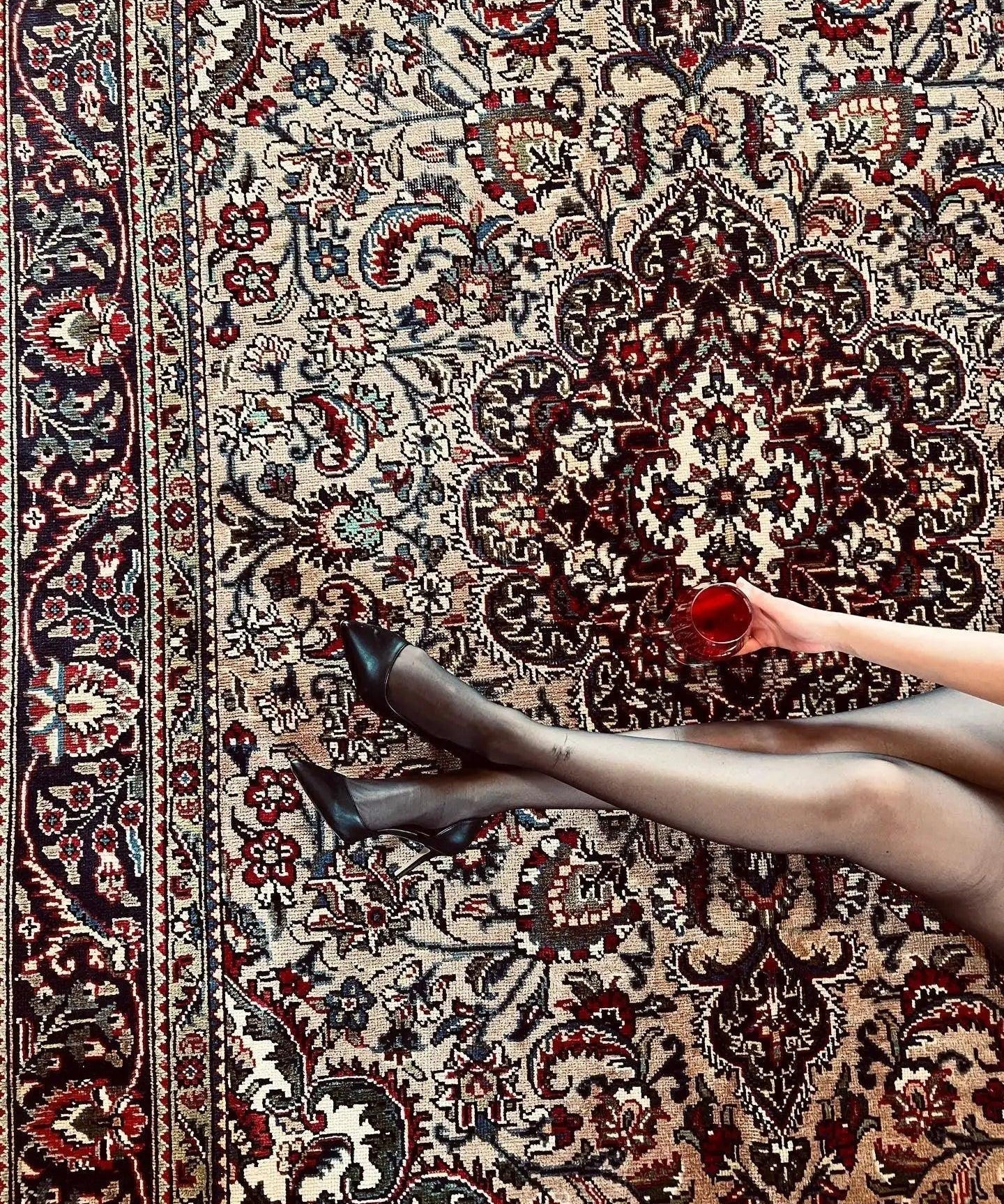 Persian Tabriz-style rug with ornate medallion and floral motifs, cream and dark red