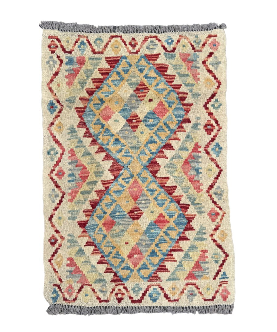 Afghan kilim rug with cream base, blue and red geometric diamond patterns, fringed edges