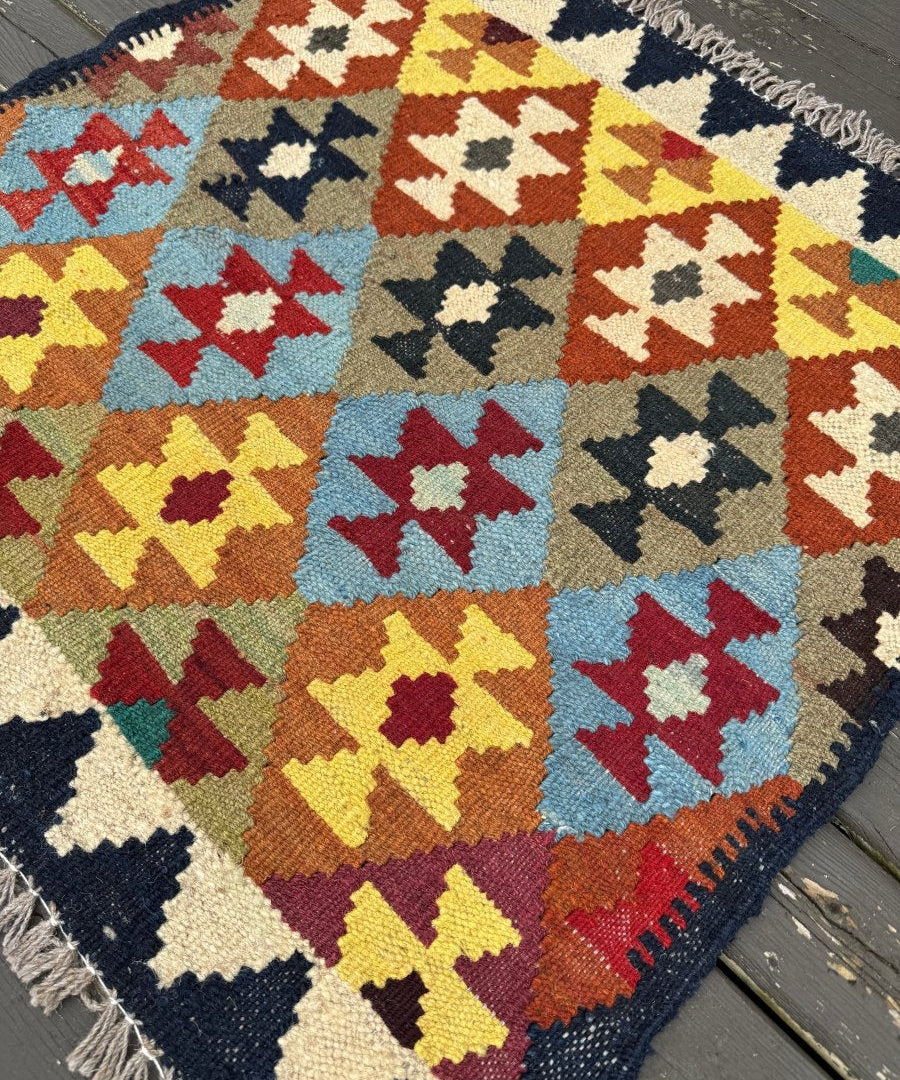 Geometric Afghan kilim rug with multicolor diamond pattern and fringed border