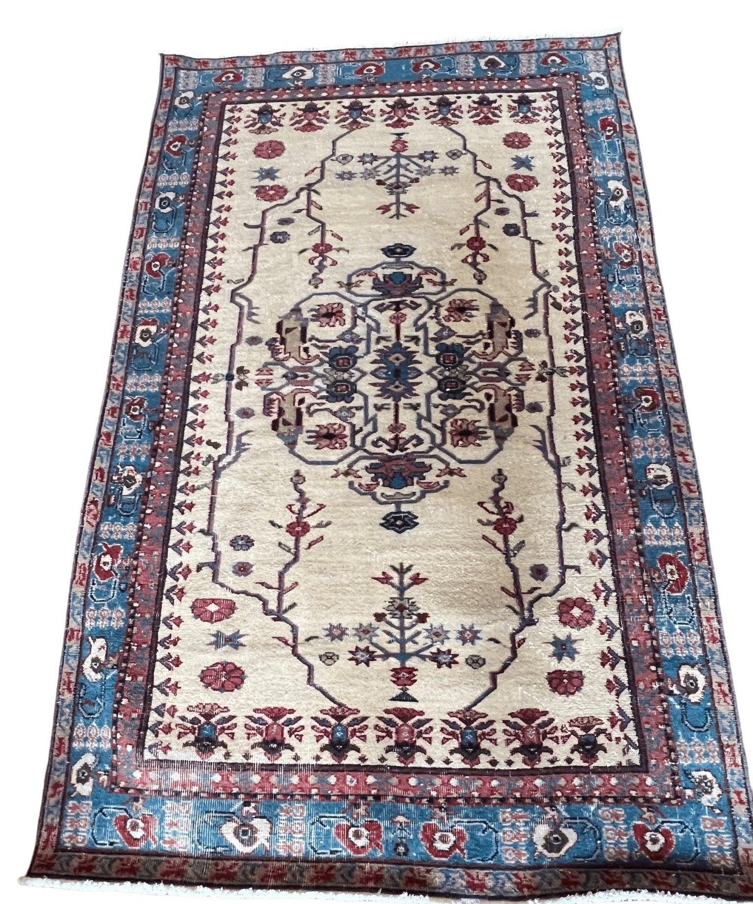 Turkish Isparta rug, cream center with blue corners and red floral vine border