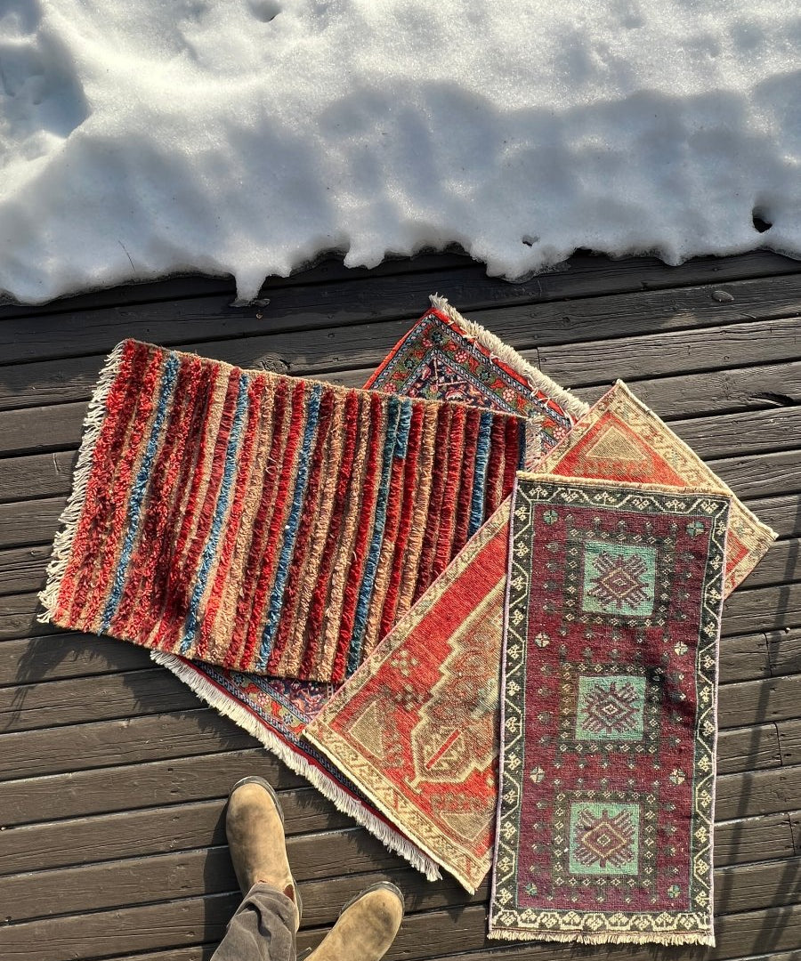 Turkish mini rug with striped and geometric panels, tassel fringe, teal and red tones