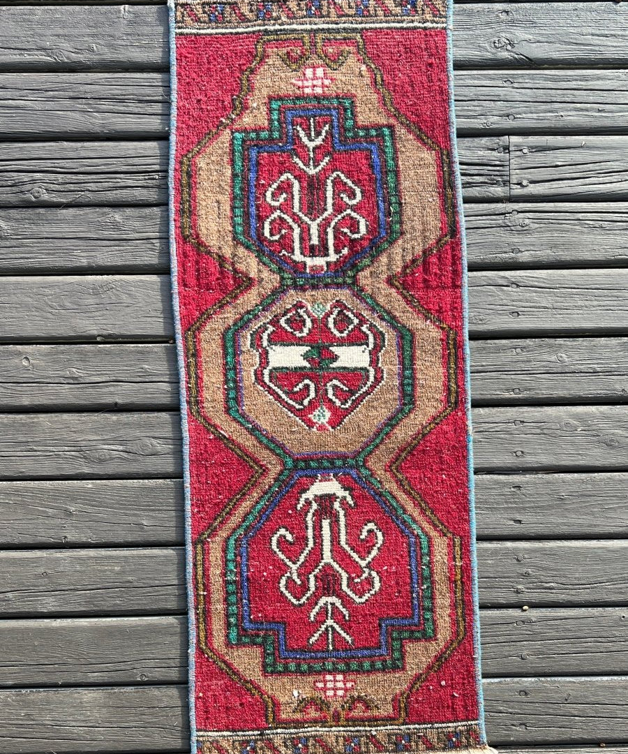 Turkish mini rug, red with geometric medallion, blue accents, beige border, fringed edge