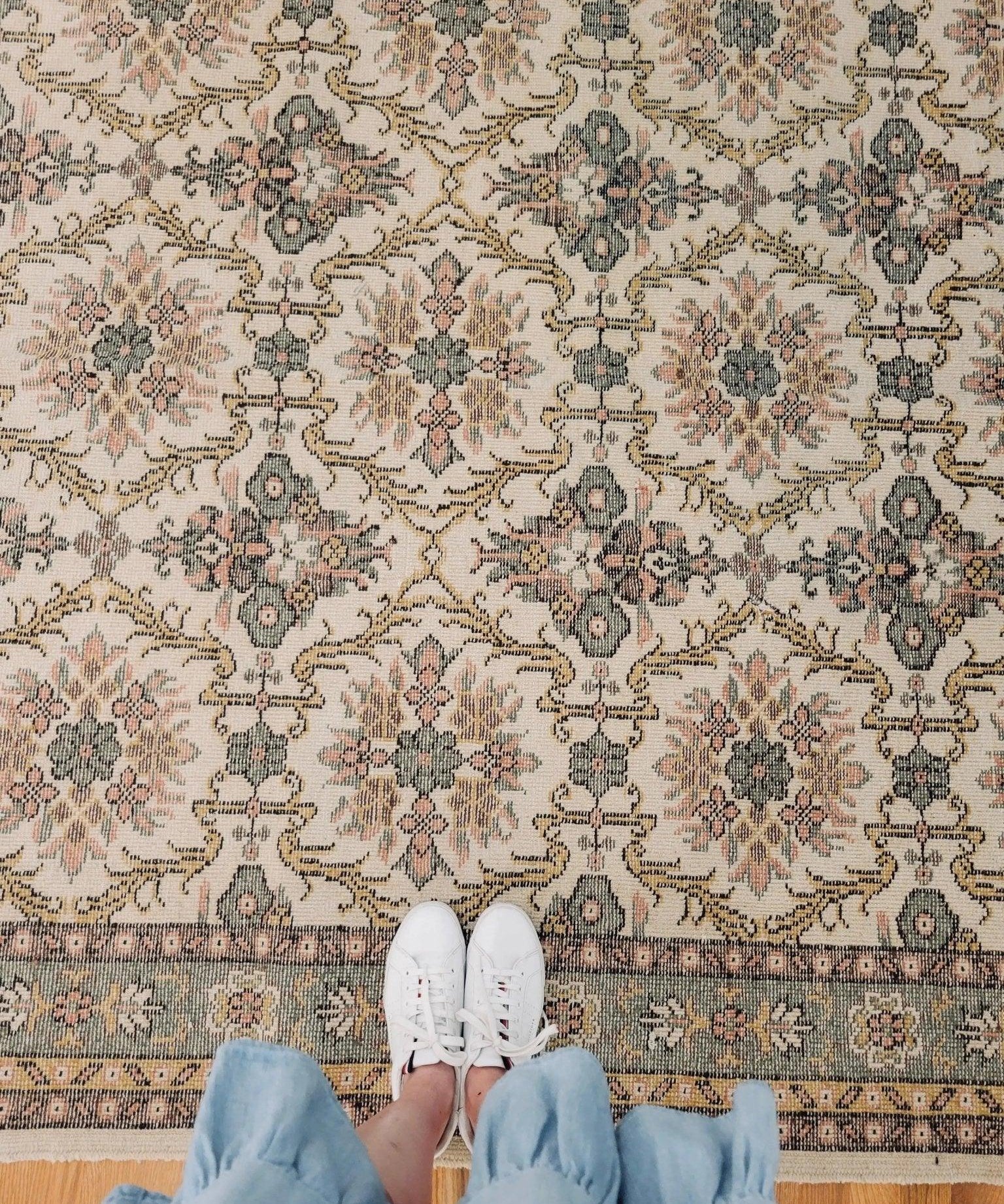 Vintage Oushak rug with cream field, navy and rust medallions, geometric border