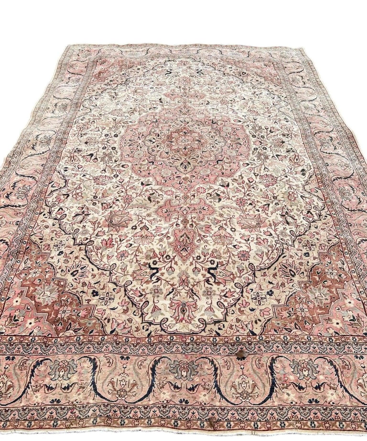Vintage Turkish rug with faded pink center medallion and cream floral overall pattern
