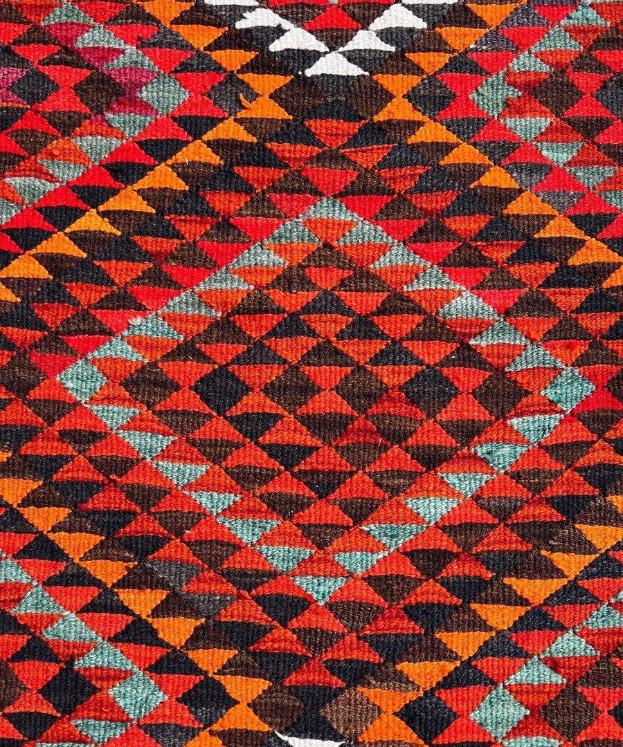 Multicolor geometric runner rug with tightly woven diamond pattern in red, orange, blue, green